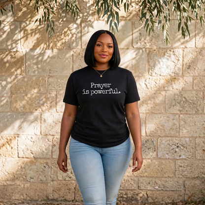 Black woman walking toward camera in black Prayer is powerful t-shirt serene peaceful smile