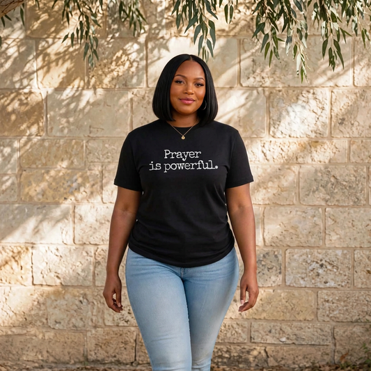 Black woman walking toward camera in black Prayer is powerful t-shirt serene peaceful smile